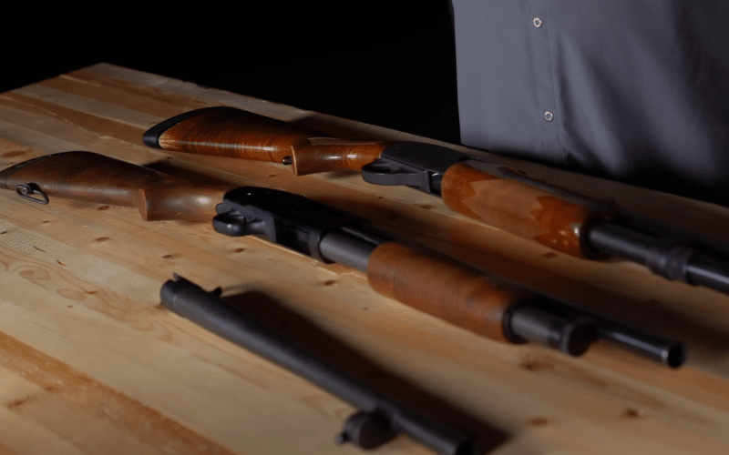 two shotguns seen on a wooden table 