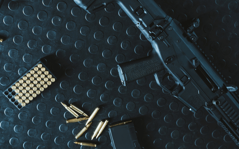 Black gun and ammo on a surface