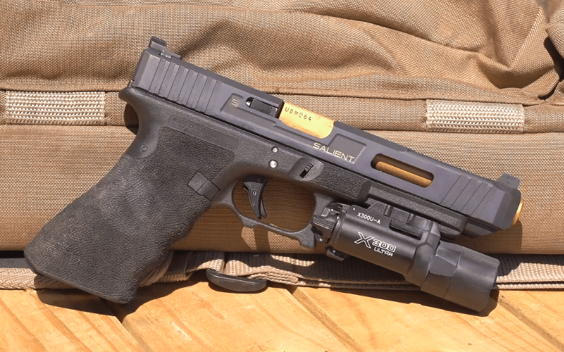 Black pistol lying against a bag