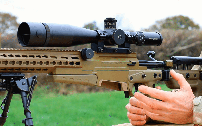 Sniper looking through eye piece on optic