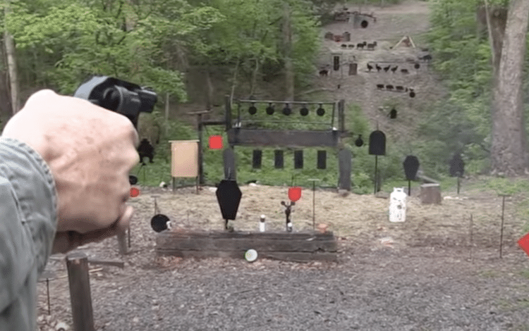 Revolver aimed at metal targets in a field
