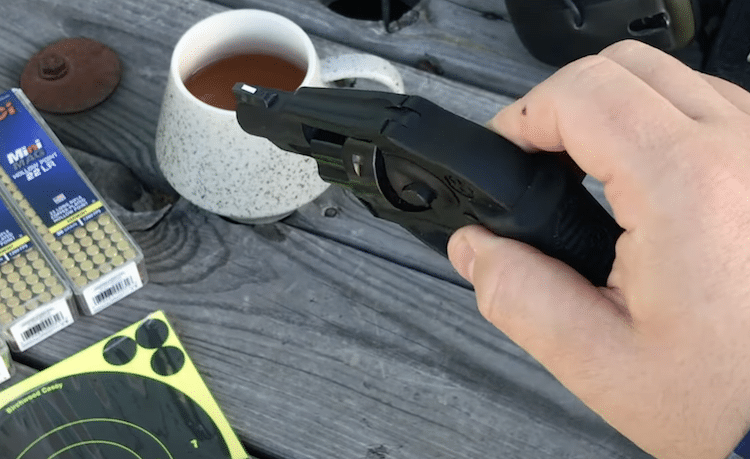 Ruger LCR held between two fingers
