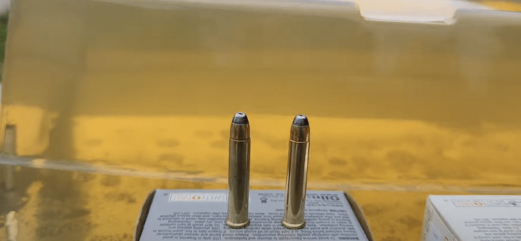 .22 Winchester Magnum Rimfire bullets on top of its box