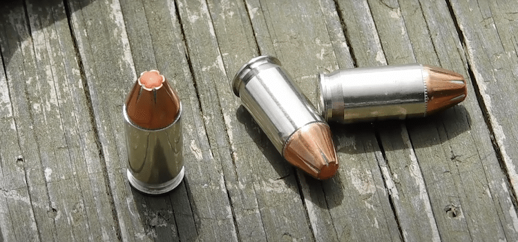 Three 380 bullets on a wooden platform