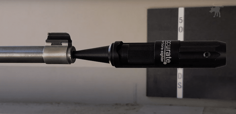 Image of a boresighter inserted into the muzzle of a rifle