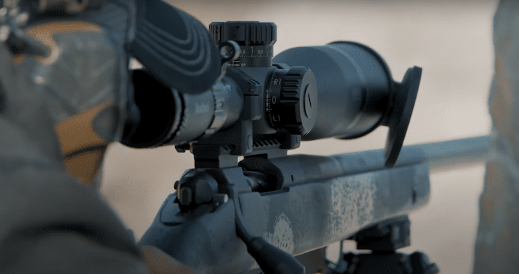 A person looking through the scope