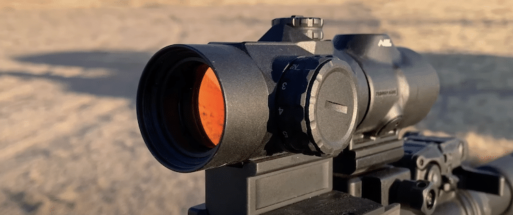 Red dot sight mounted on a rifle