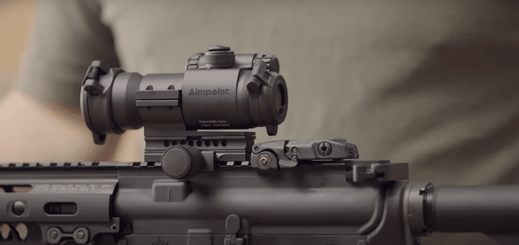 Aimpoint Optic mounted on a rifle