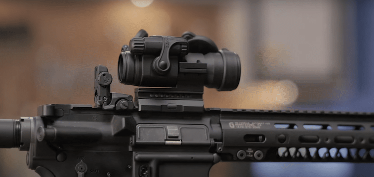 Red dot sight mounted on a rifle