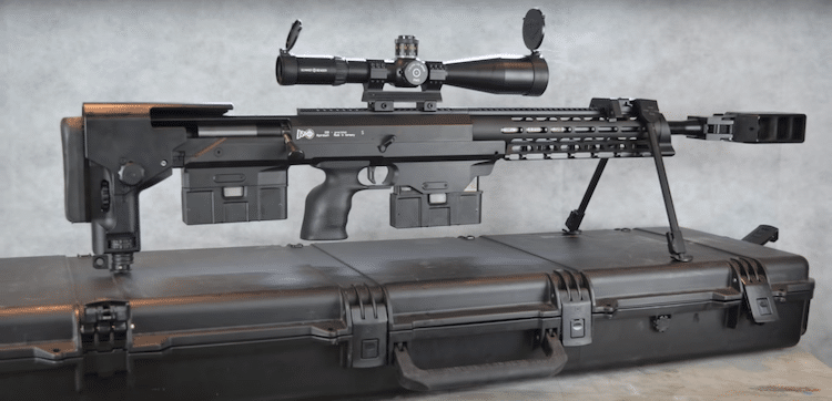 Sniper rifle with a mounted scope on top of a black case 