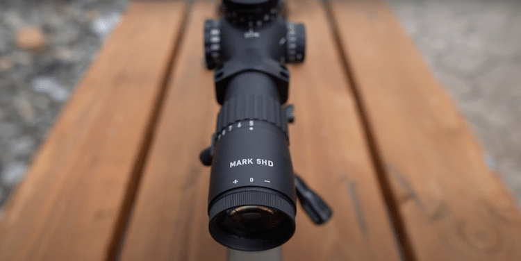 Leupold Mark 5HD 5-25x56mm on top of a wooden table