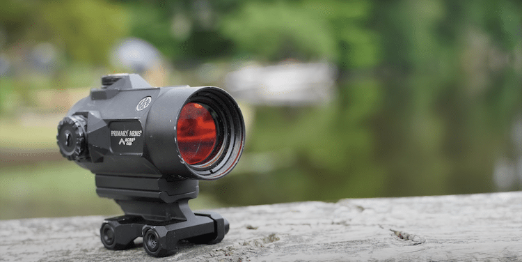 Primary Arms SLx MD-25 on top of a wood, and a blurry background
