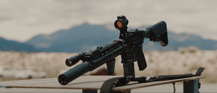 Sig Sauer Romeo 5 mounted on a rifle, and a mountain on the background