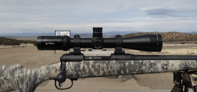 Vortex Optics Viper HS-T 6-24x50mm mounted on a rifle and a desert in the background
