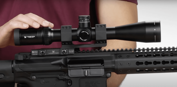 Hand holding the Vortex Optics Viper HS-T 6-24x50mm mounted on a rifle