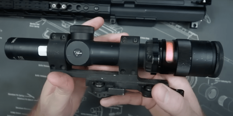 Trijicon TR24 AccuPoint scope held in both hands